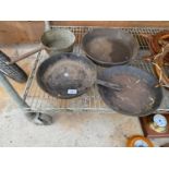 THREE CAST IRON FRYING PANS AND A BRASS SAUCEPAN