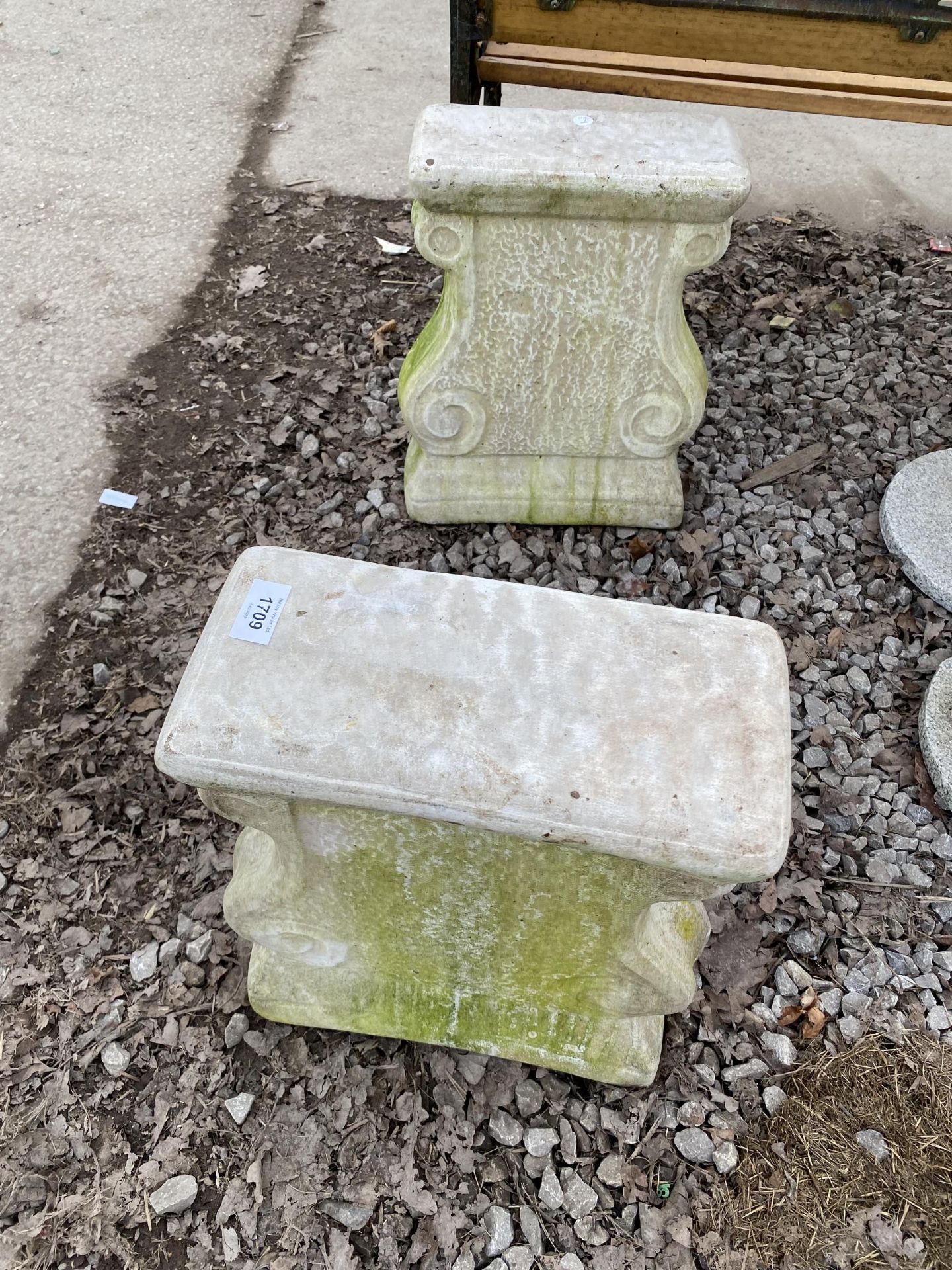 A PAIR OF RECONSTITUTED STONE BENCH PEDESTALS