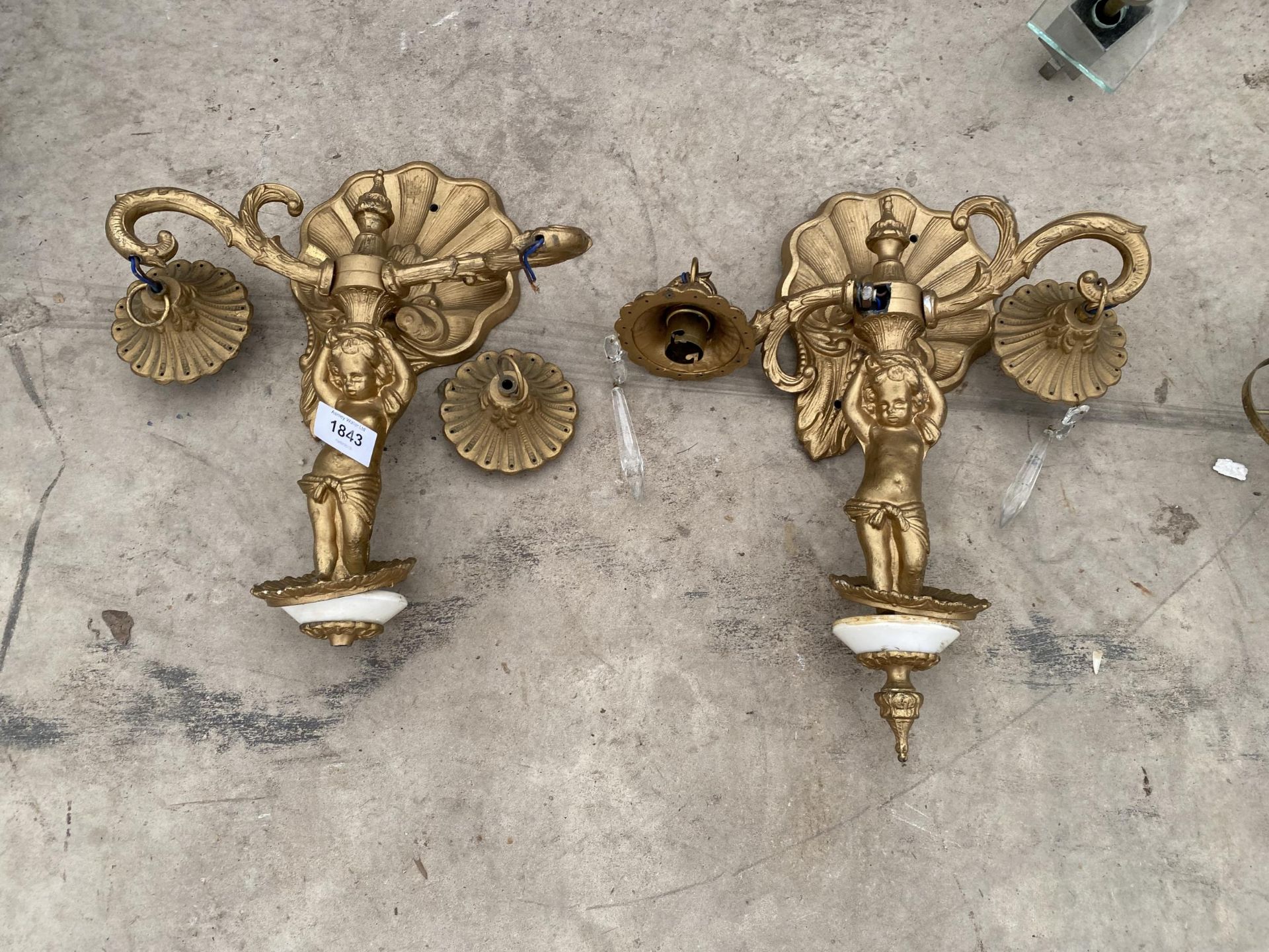 A PAIR OF GILT CHERUB DESIGN WALL LIGHTS