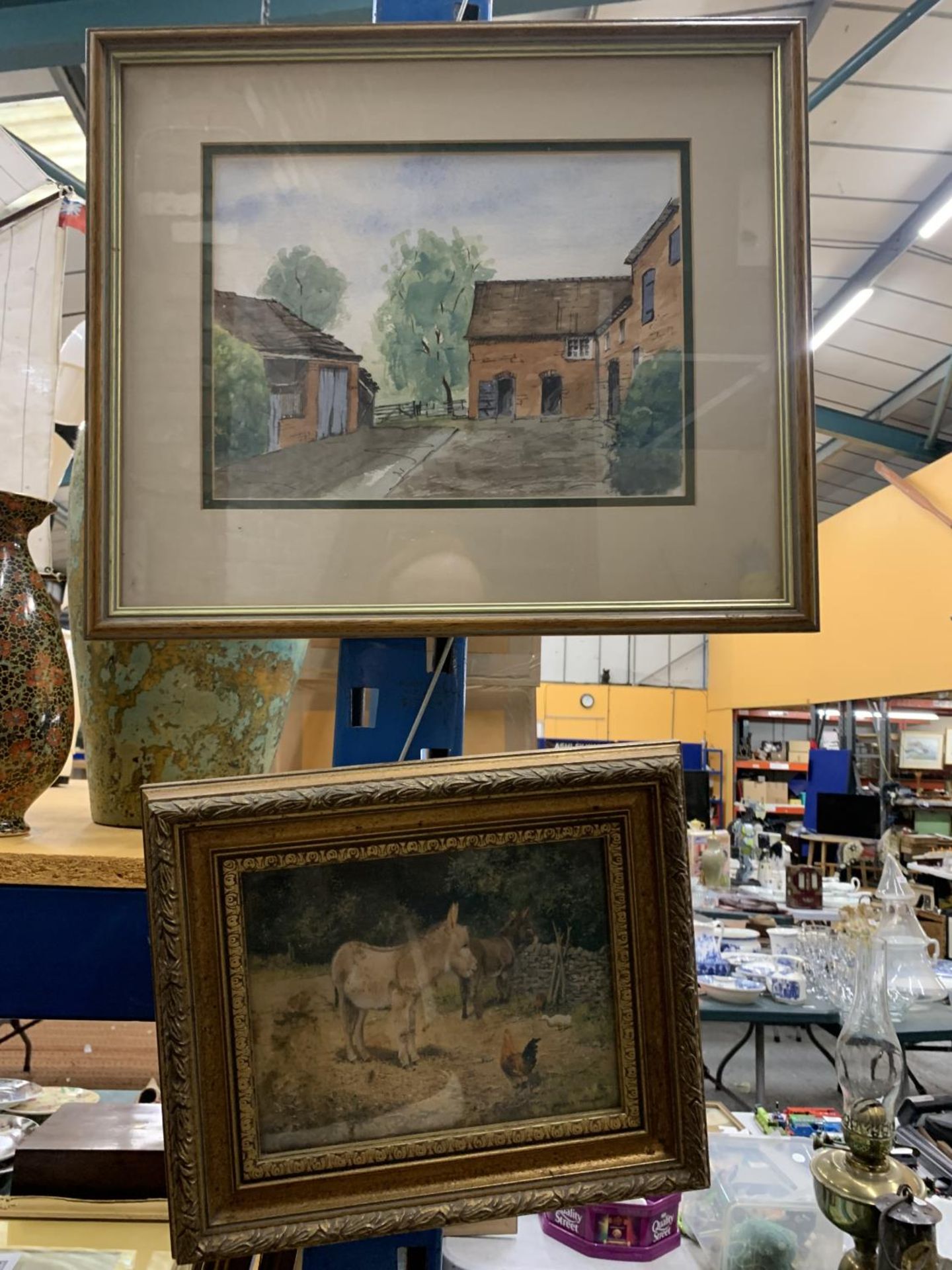 A PEN AND INK WATERCOLOUR OF A BARN SIGNED BOB HARRIS AND A FRAMED PRINT OF A DONKEY