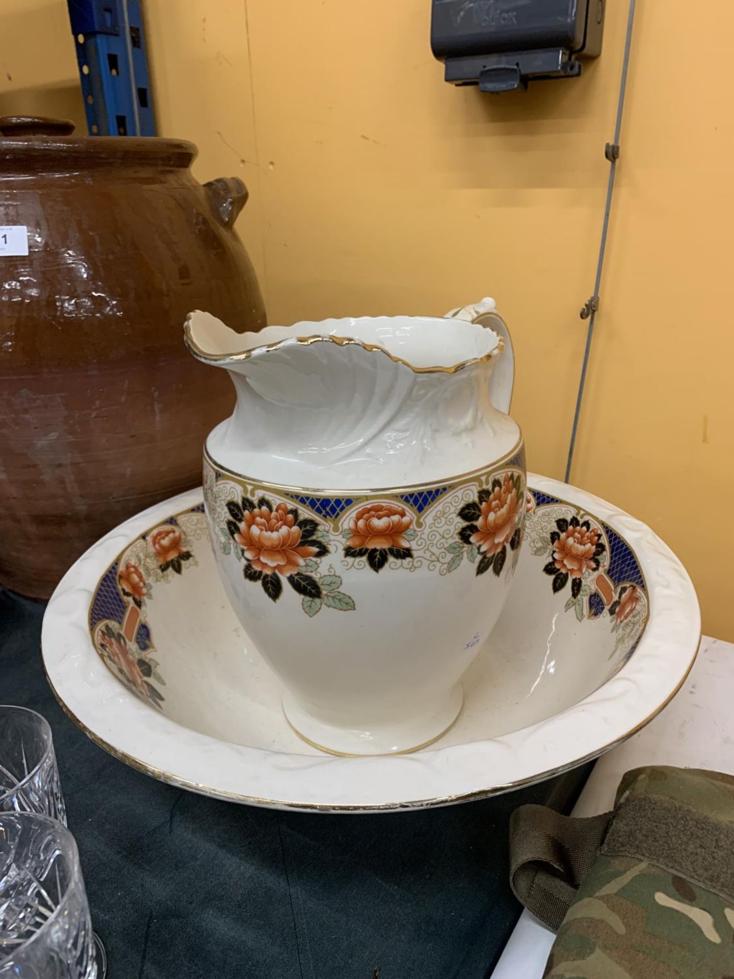 A LARGE FLORAL DECORATED WASHBOWL AND JUG WITH 'WINCHESTER' IMPRESSED ON THE BASE