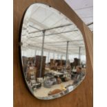 AN OVAL ART DECO UNFRAMED BEVELED EDGE WALL MIRROR