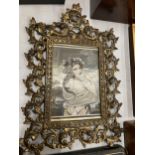 A VINTAGE ORNATE BRASS PICTURE FRAME, 31 X 42CM