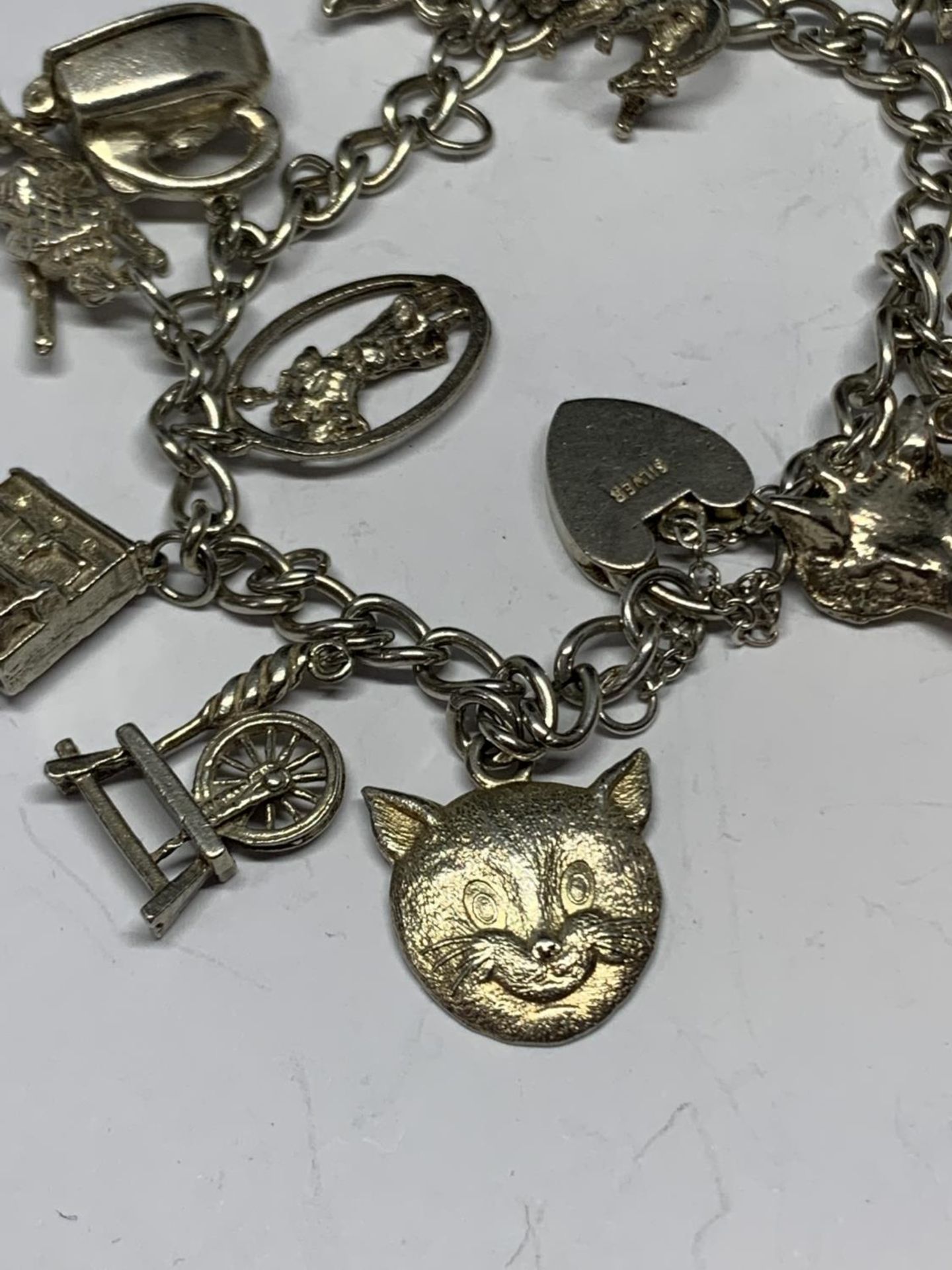 A SILVER BRACELET WITH THIRTEEN CHARMS - Image 4 of 4