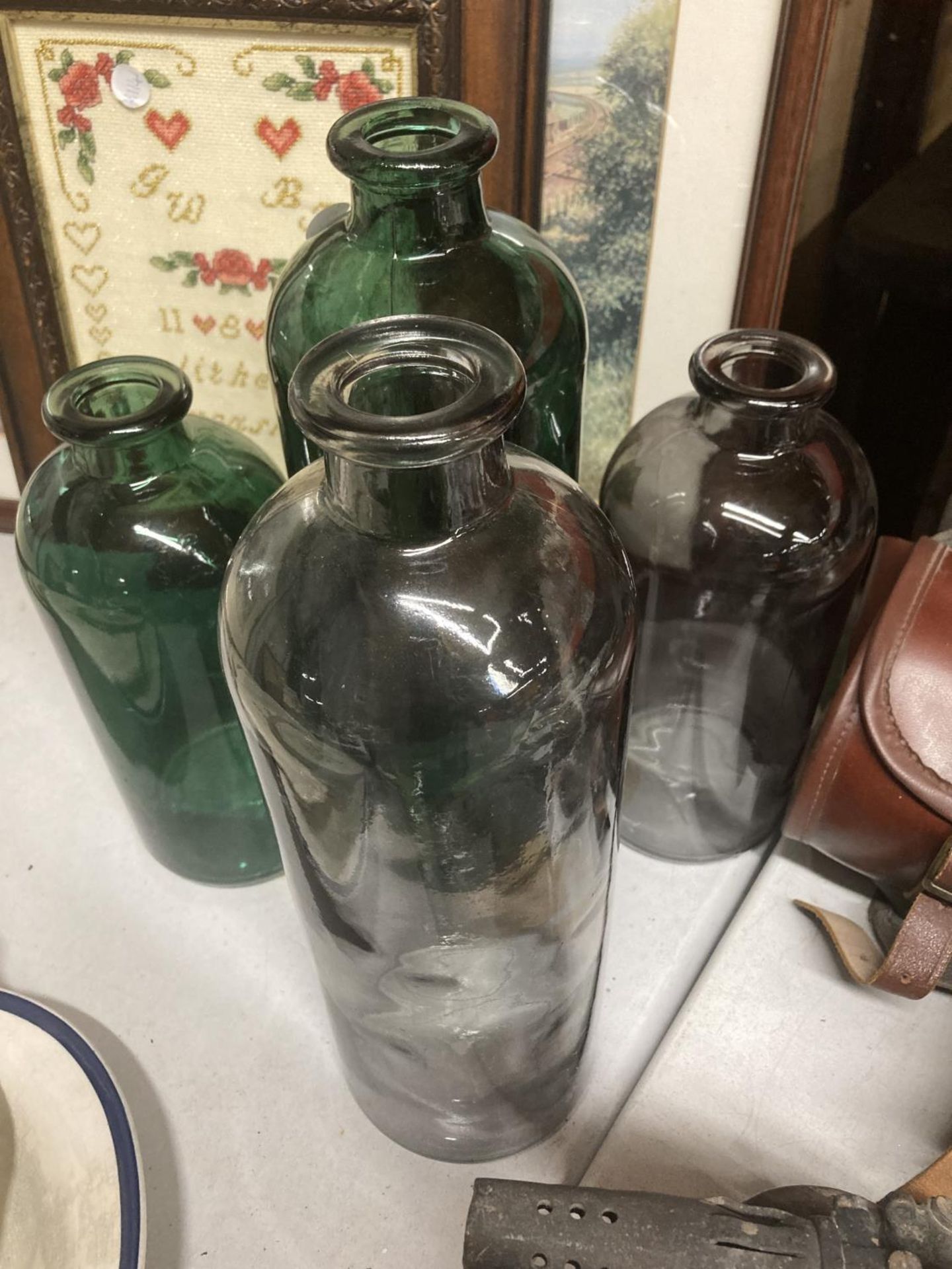 FOUR COLOURED GLASS BOTTLES