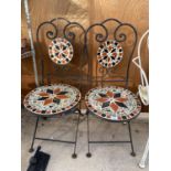 A PAIR OF WORUGHT IRON AND TILED FOLDING GARDEN CHAIRS