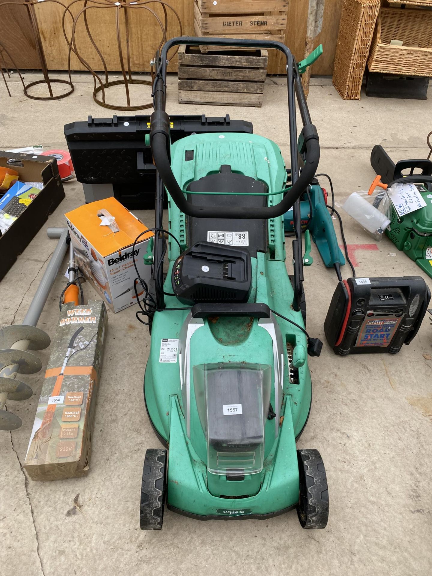 A GARDENLINE BATTERY POWERED LAWN MOWER COMPLETE WITH CHARGER