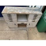 A VINTAGE WOODEN CABINET CONTAINING ELEVEN DRAWERS AND TWO CUPBOARDS