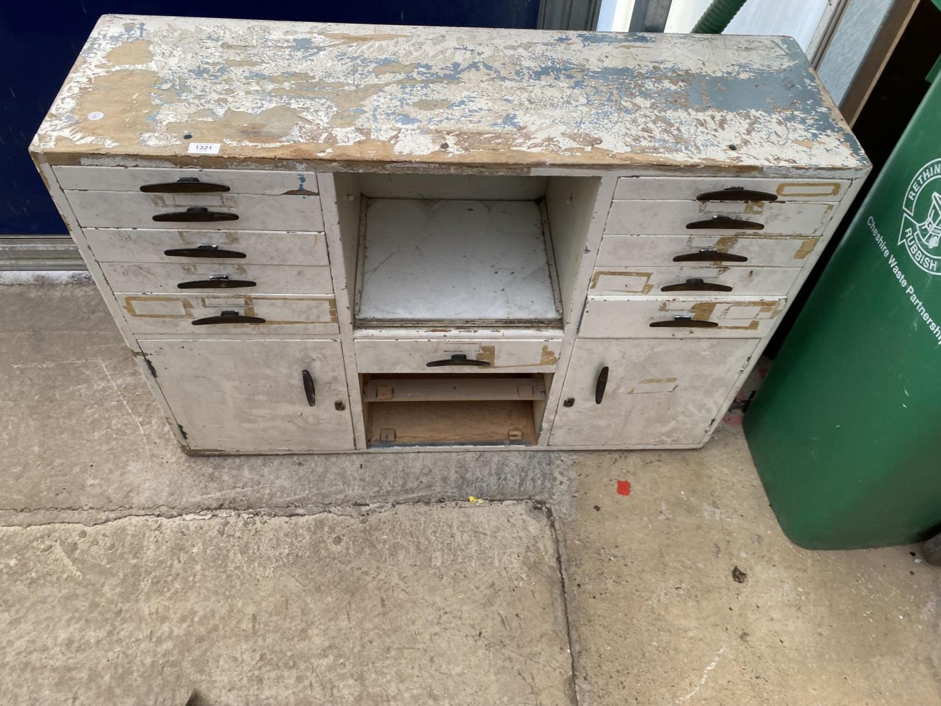 A VINTAGE WOODEN CABINET CONTAINING ELEVEN DRAWERS AND TWO CUPBOARDS