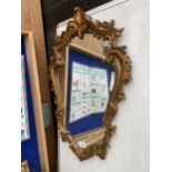 A DECORATIVE FRAMED WALL MIRROR