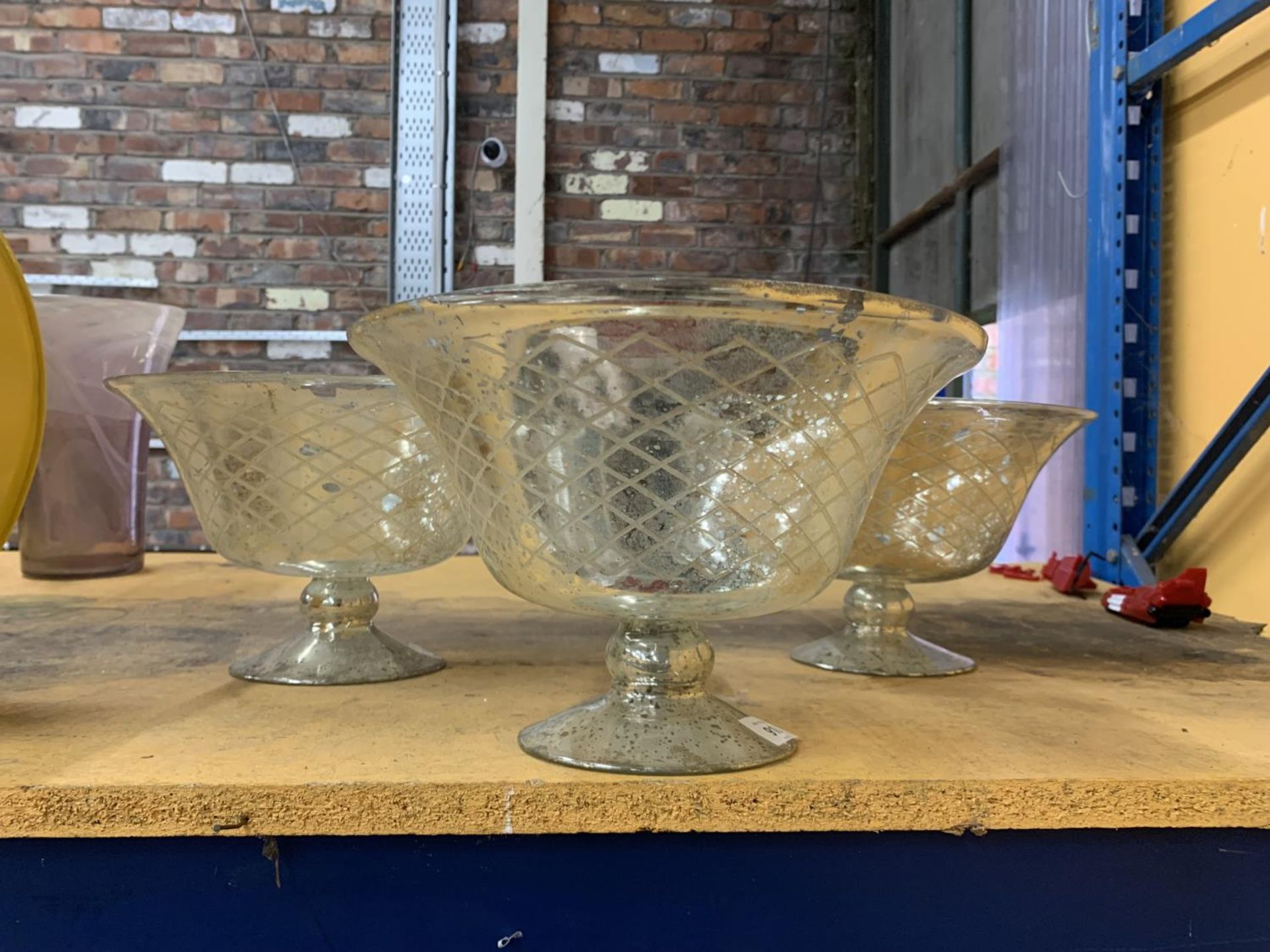 THREE LARGE GLASS FOOTED BOWLS