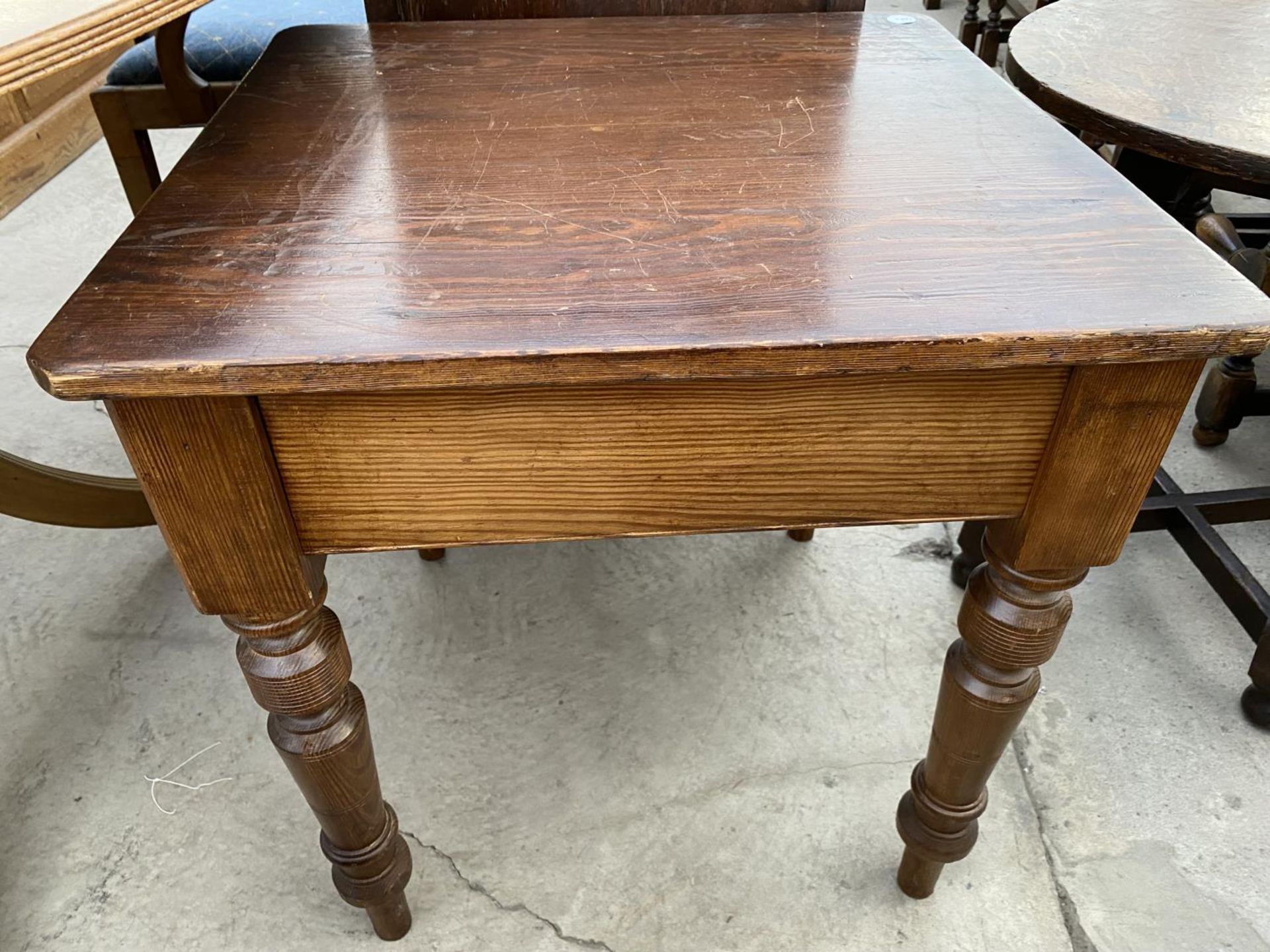 A 23" DIAMETER PUB TABLE AND PINE LAMP TABLE ON TURNED LEGS, 24" SQUARE - Image 2 of 3