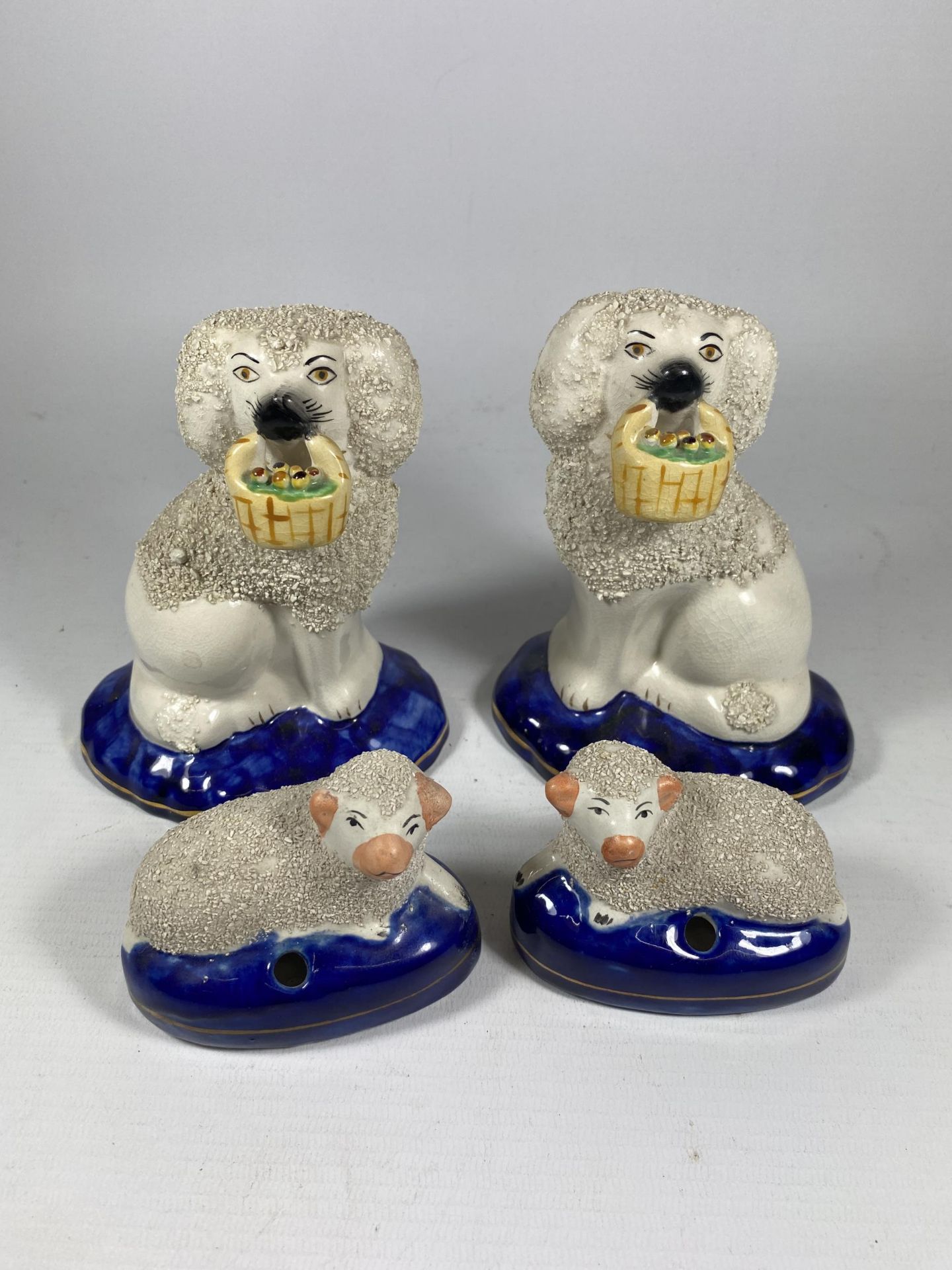 TWO PAIRS OF STAFFORDSHIRE POTTERY SPANIELS