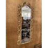 A DECORATIVE FRAMED WALL MIRROR