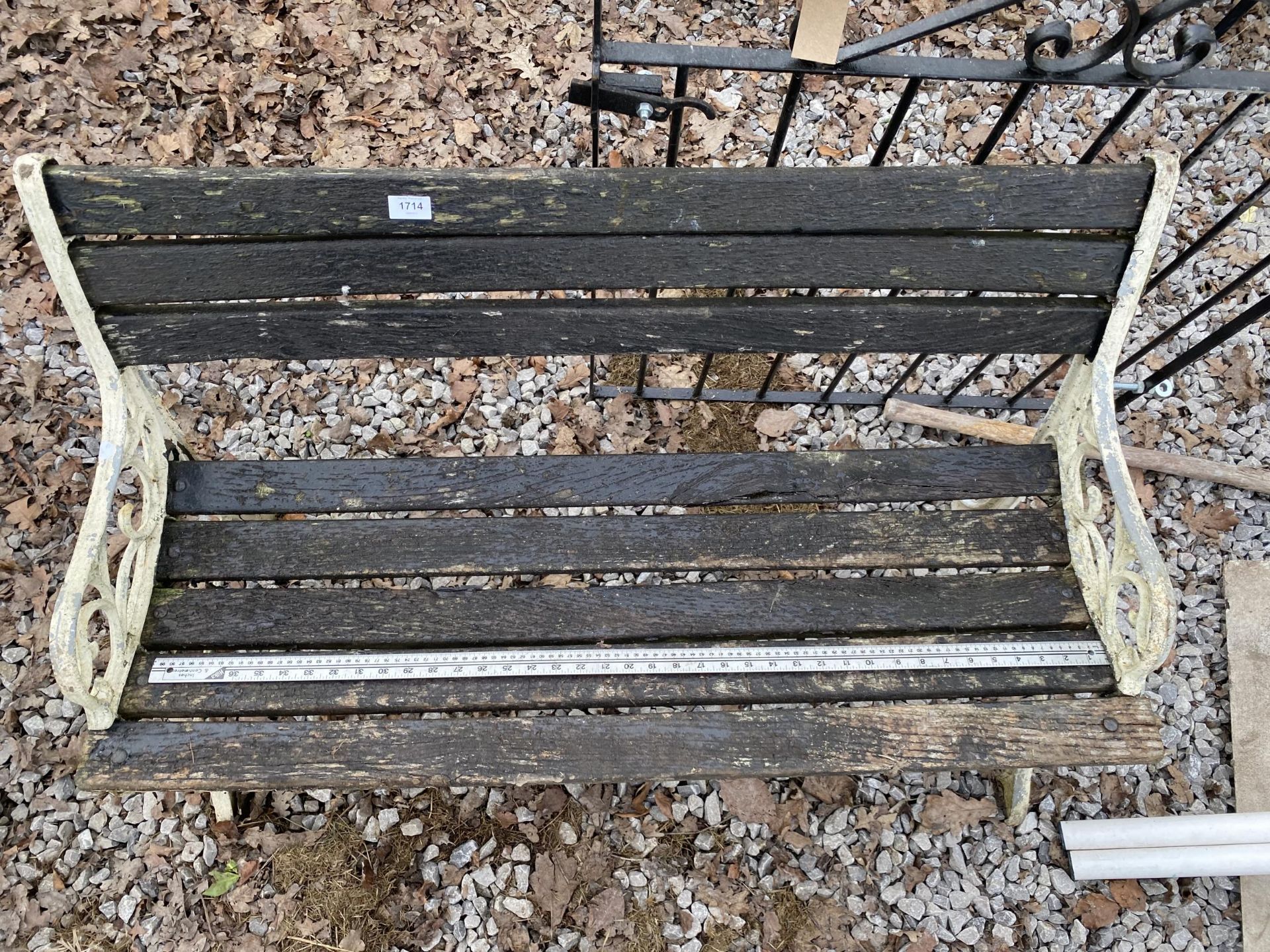 A WOODEN SLATTED GARDEN BENCH WITH CAST BENCH ENDS - Image 2 of 2