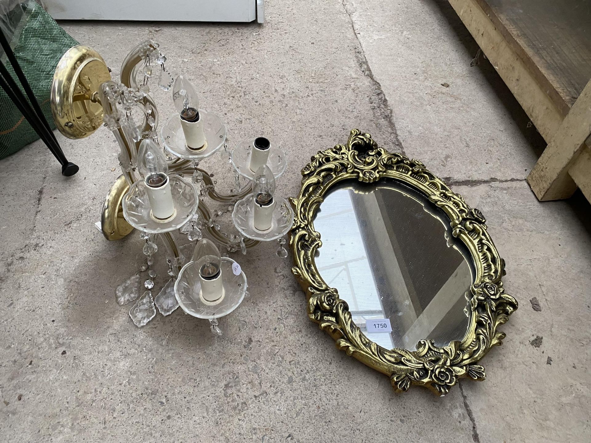 A DECORATIVE GILT FRAMED WALL MIRROR AND A LIGHT FITTING