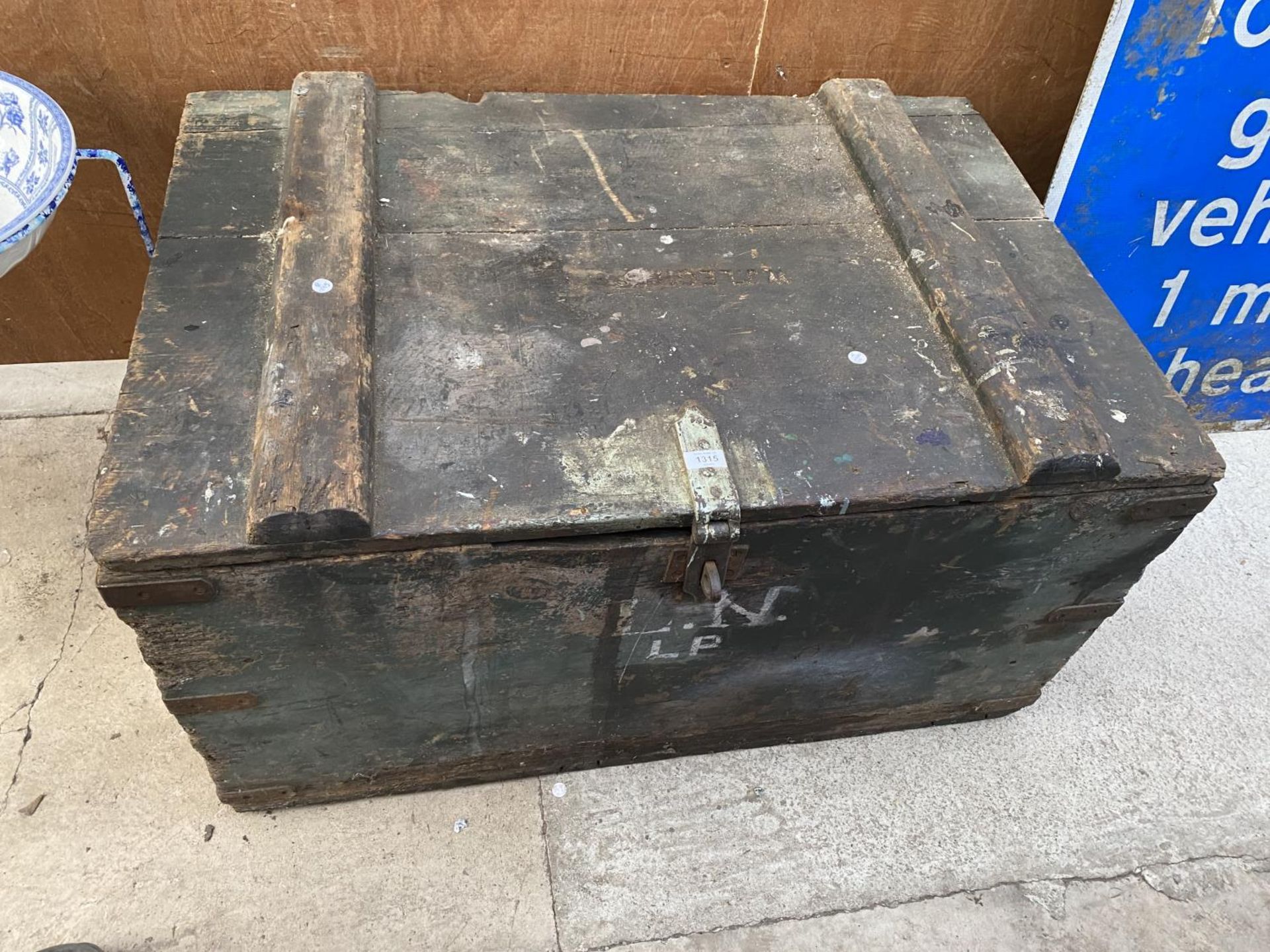 A LARGE VINTAGE WOODEN CHEST WITH METAL BANDING
