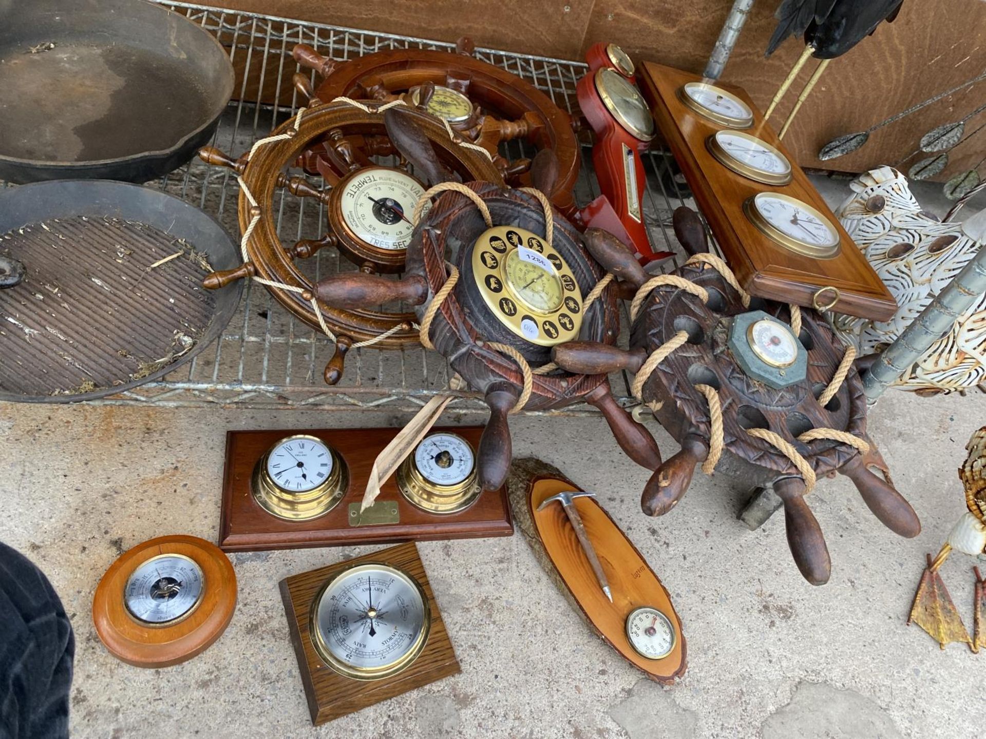 A LARGE ASSORTMENT OF CLOCKS AND BAROMETERS WITH SOME IN THE SHAPE OF SHIPS WHEELS ETC