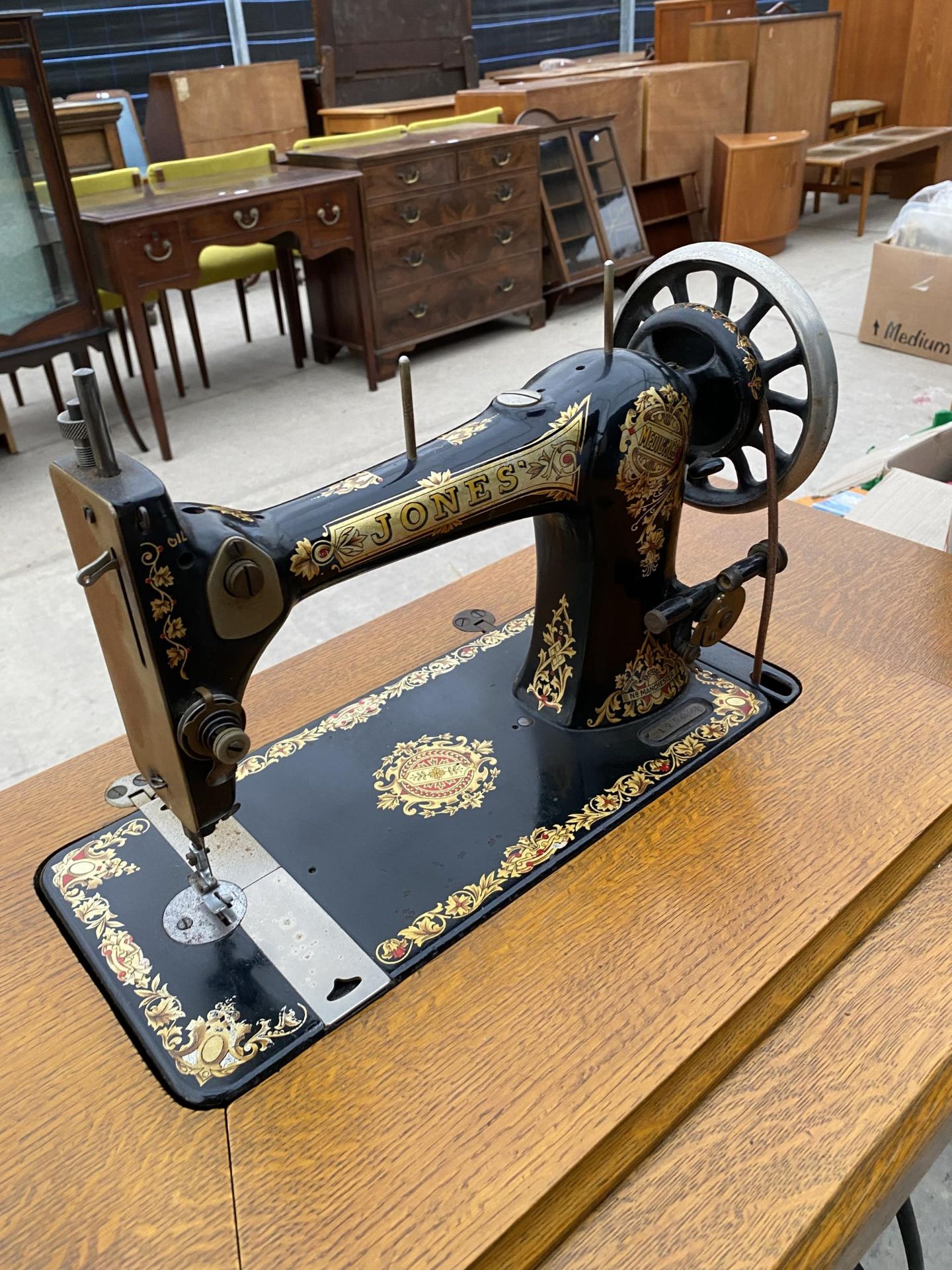 A JONES TREADLE SEWING MACHINE WITH CAST IRON BASE - Image 2 of 3