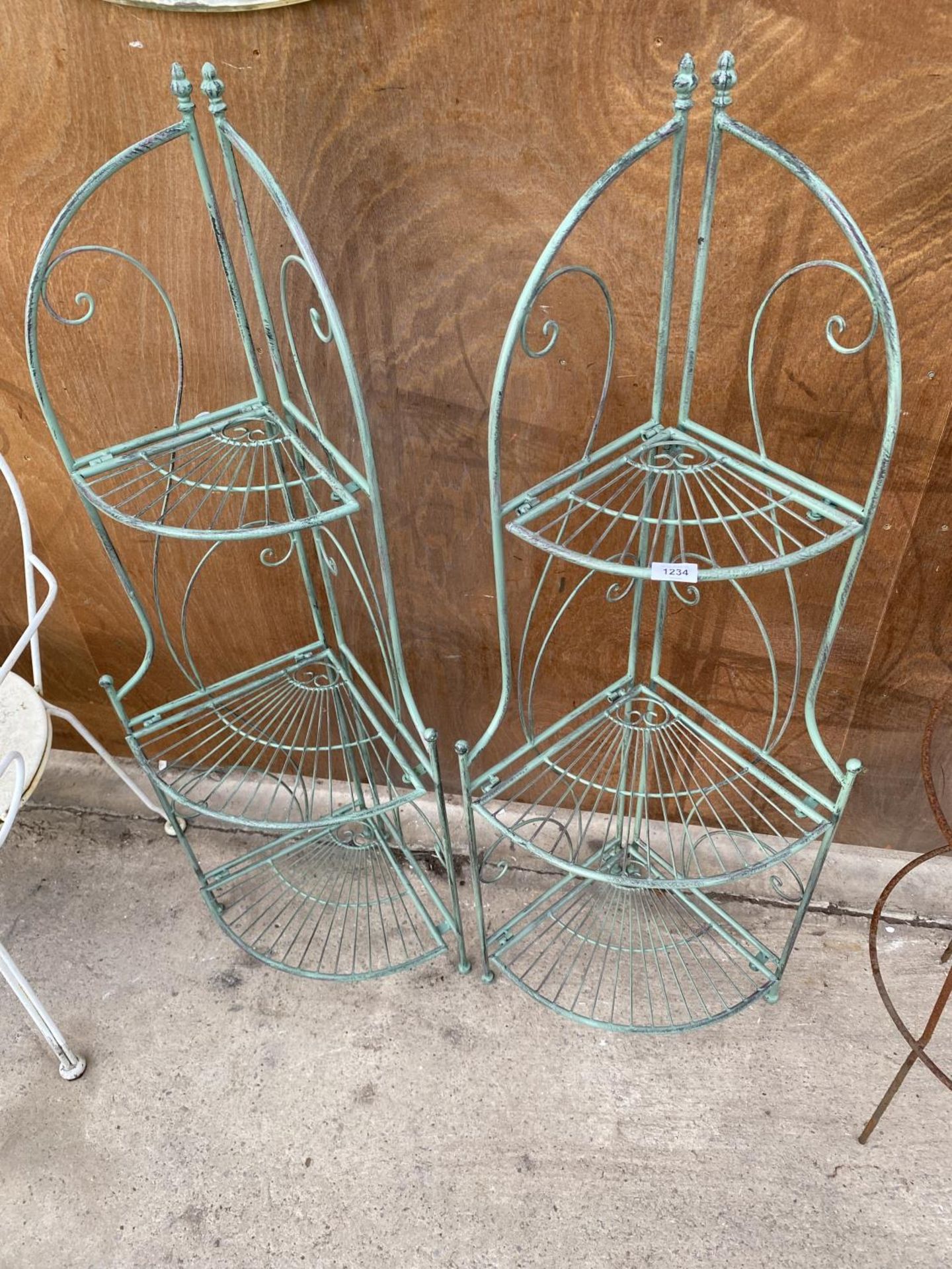 A PAIR OF GREEN PAINTED WROUGHT IRON THREE TIER CORNER WHAT-KNOTS