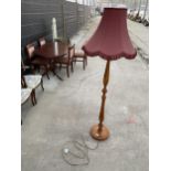 A BEECH STANDARD LAMP COMPLETE WITH BURGUNDY SHADE