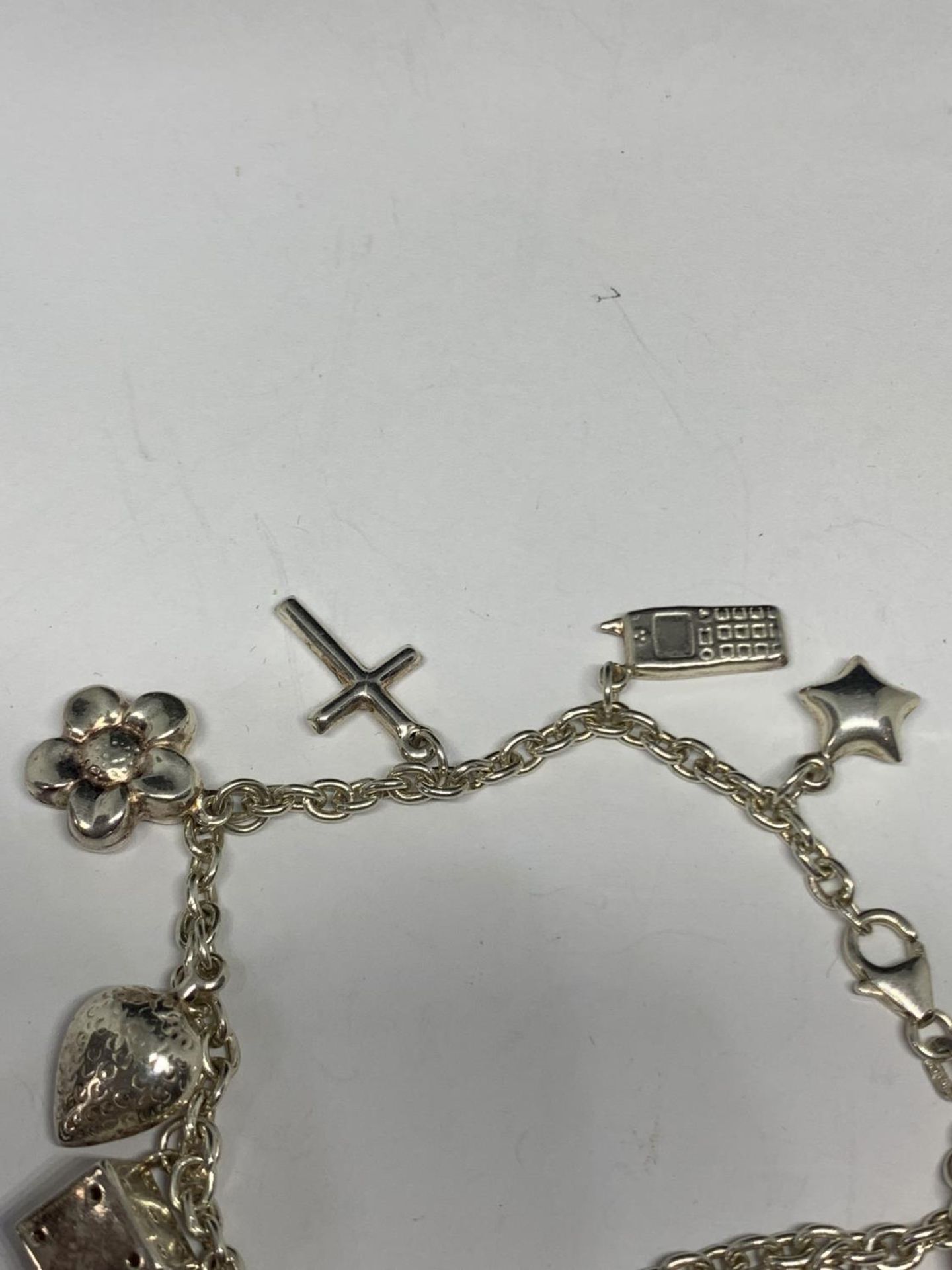 A SILVER BRACELET WITH ELEVEN CHARMS - Image 3 of 4