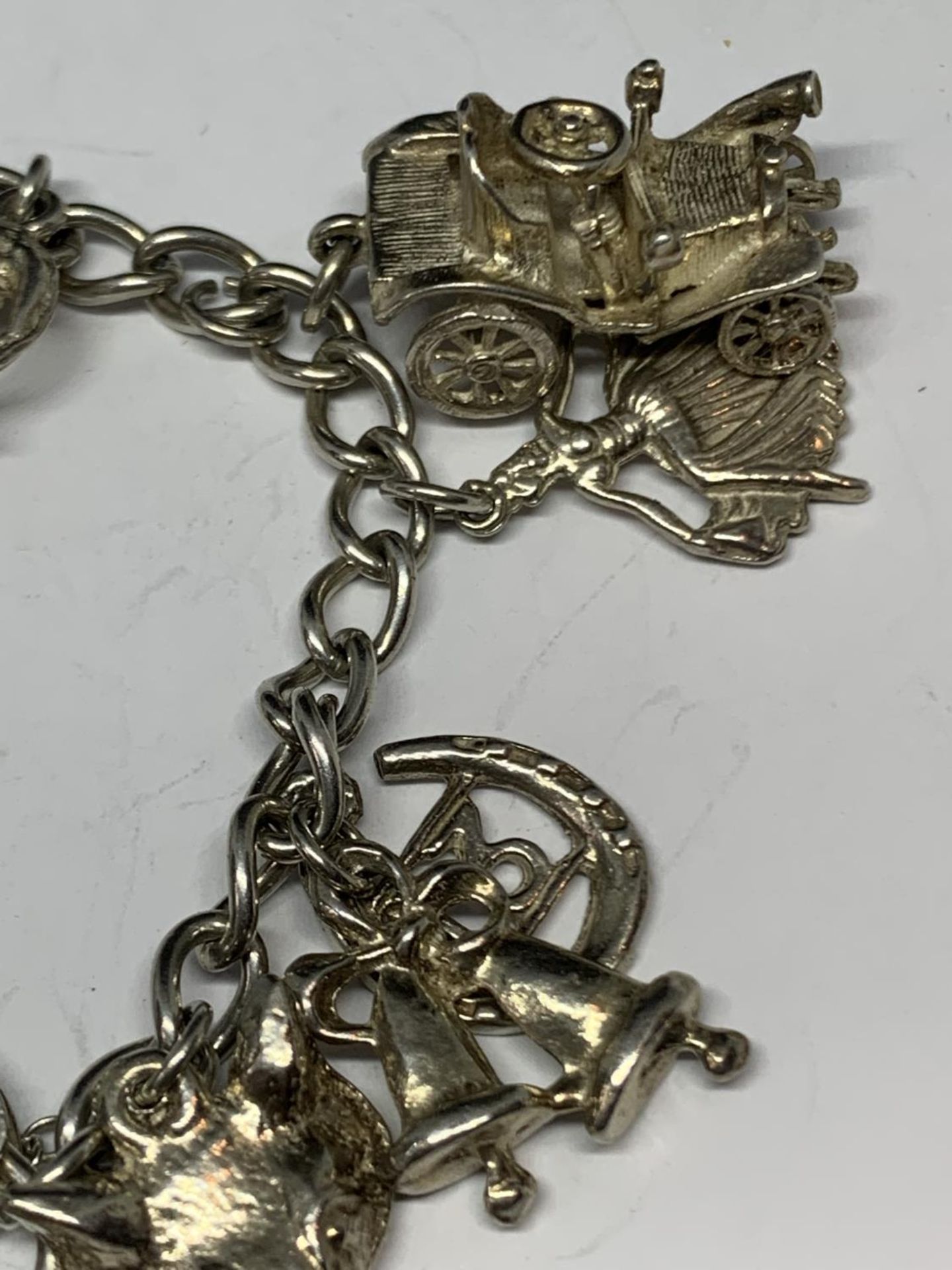 A SILVER BRACELET WITH THIRTEEN CHARMS - Image 3 of 4