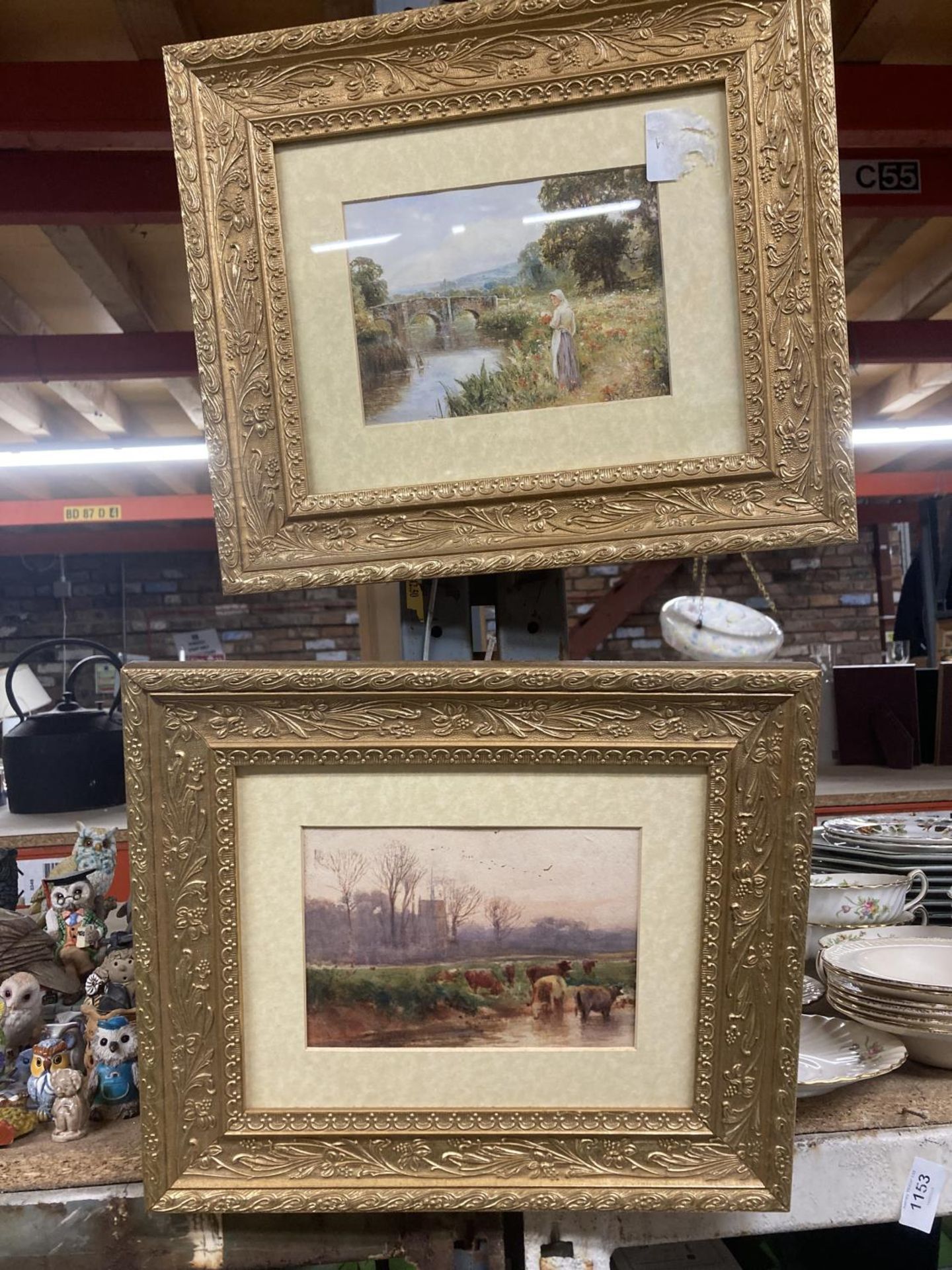 TWO ORNATE GILT FRAMED PRINTS OF CATTLE NEAR A RIVER AND A LADY COLLECTING FLOWERS BY A RIVER 35CM X