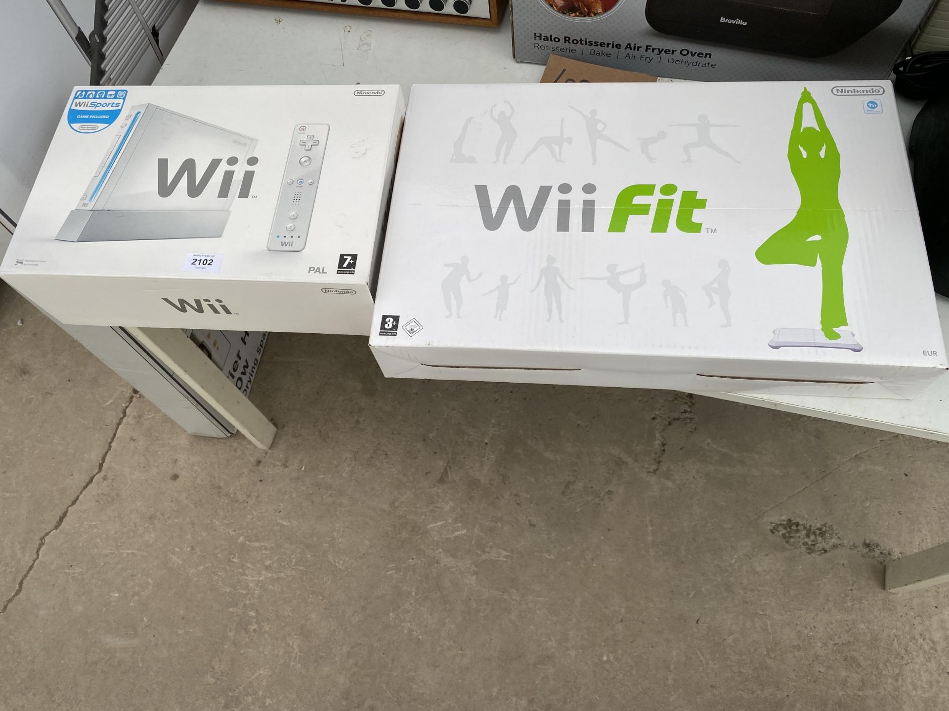 A NINTENDO WII AND A WII FIT BOARD