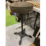 A CIRCULAR TOPPED BARSTOOL WITH CAST METAL BASE WITH PAW FEET