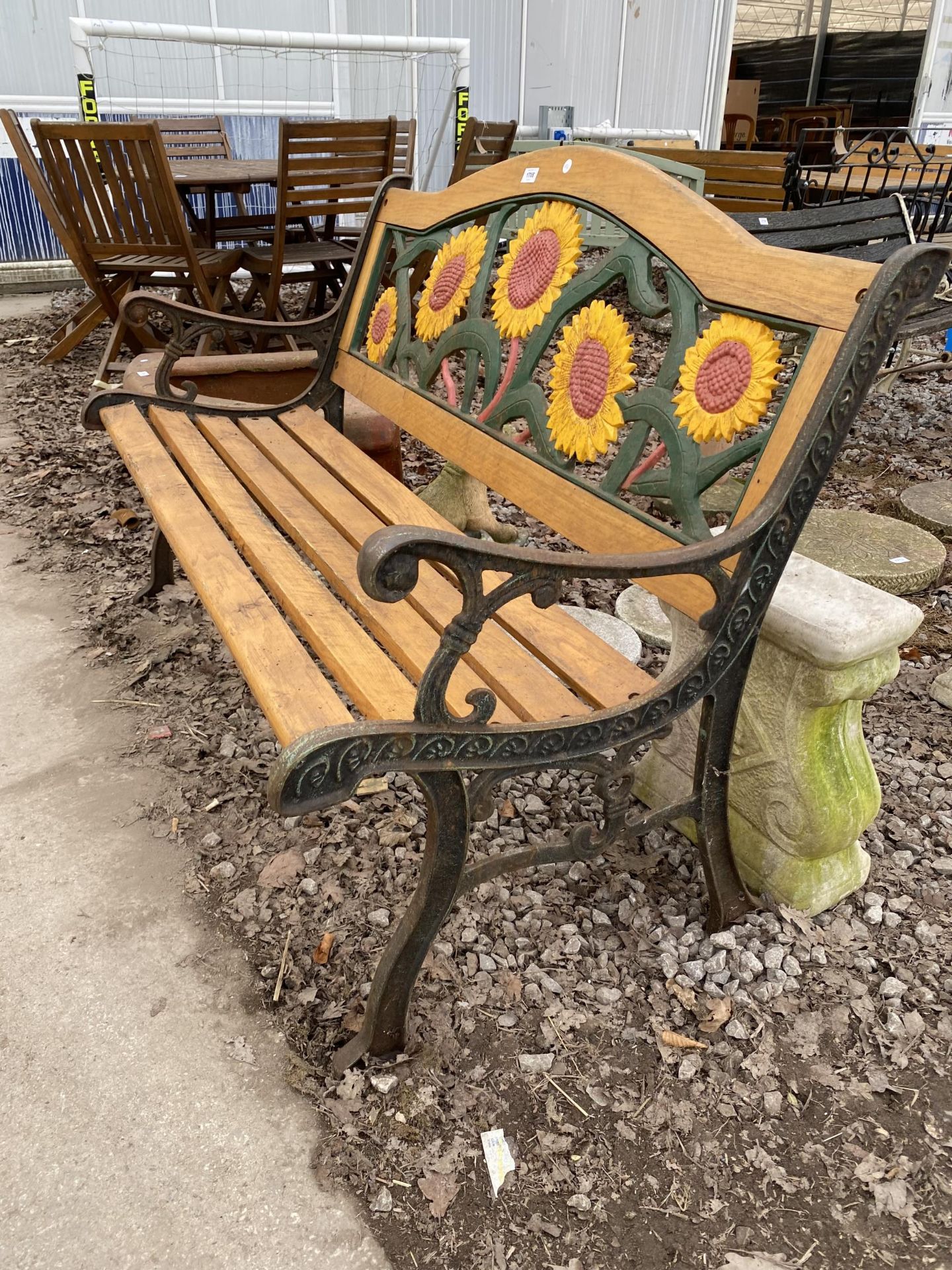 A WOODEN SLATTED GARDEN BENCH WITH CAST BENCH ENDS AND CAST SUNFLOWER DESIGN BACK - Image 2 of 2