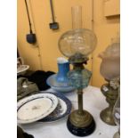 A VICTORIAN OIL LAMP WITH BRASS STEM, BLUE GLASS MIDDLE, A GLASS ENGRAVED SHADE AND A CHIMNEY HEIGHT