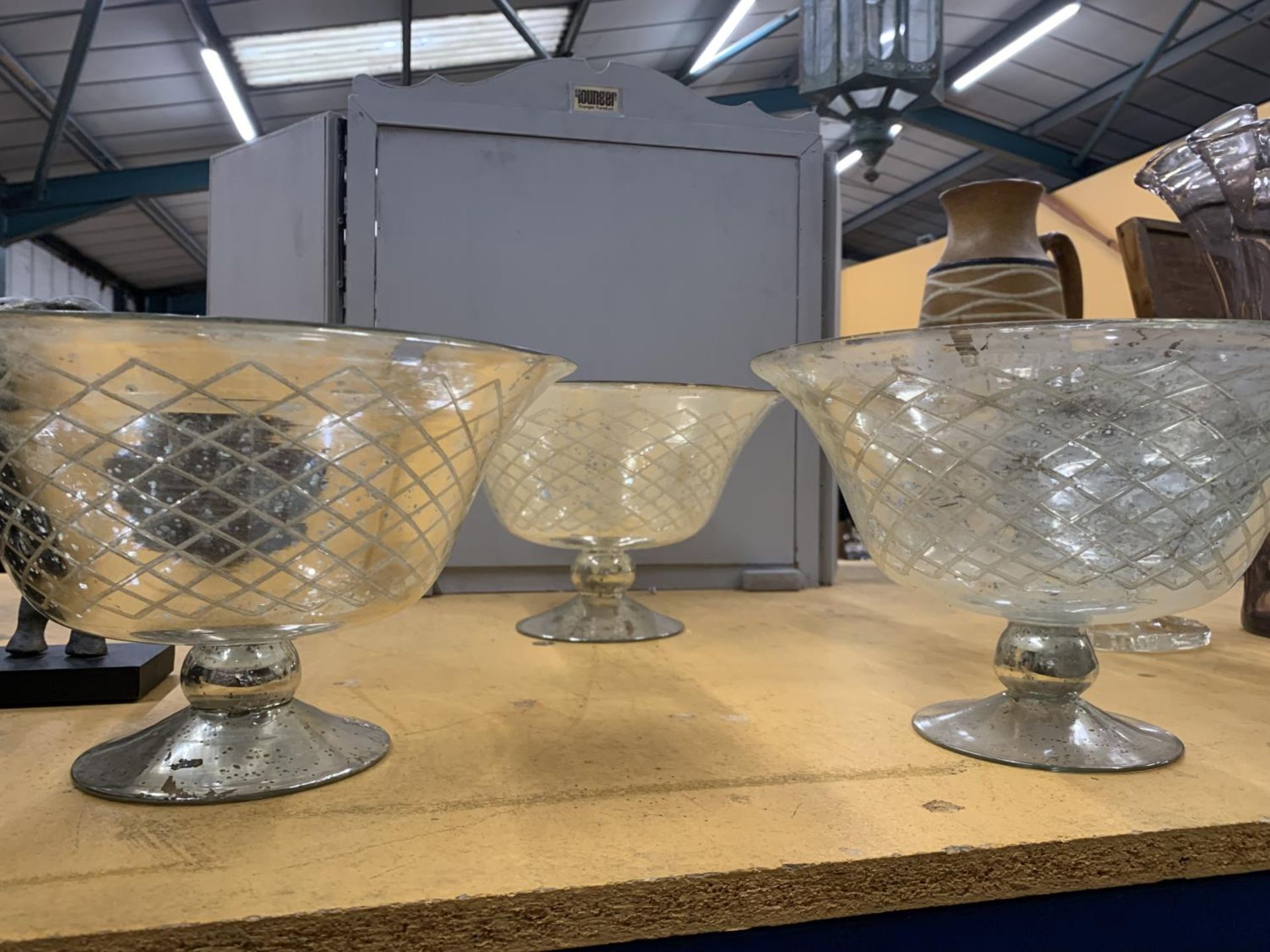 THREE LARGE GLASS FOOTED BOWLS