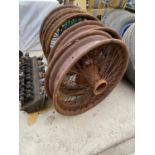 FOUR VINTAGE WHEEL RIMS AND AN ENGINE PART