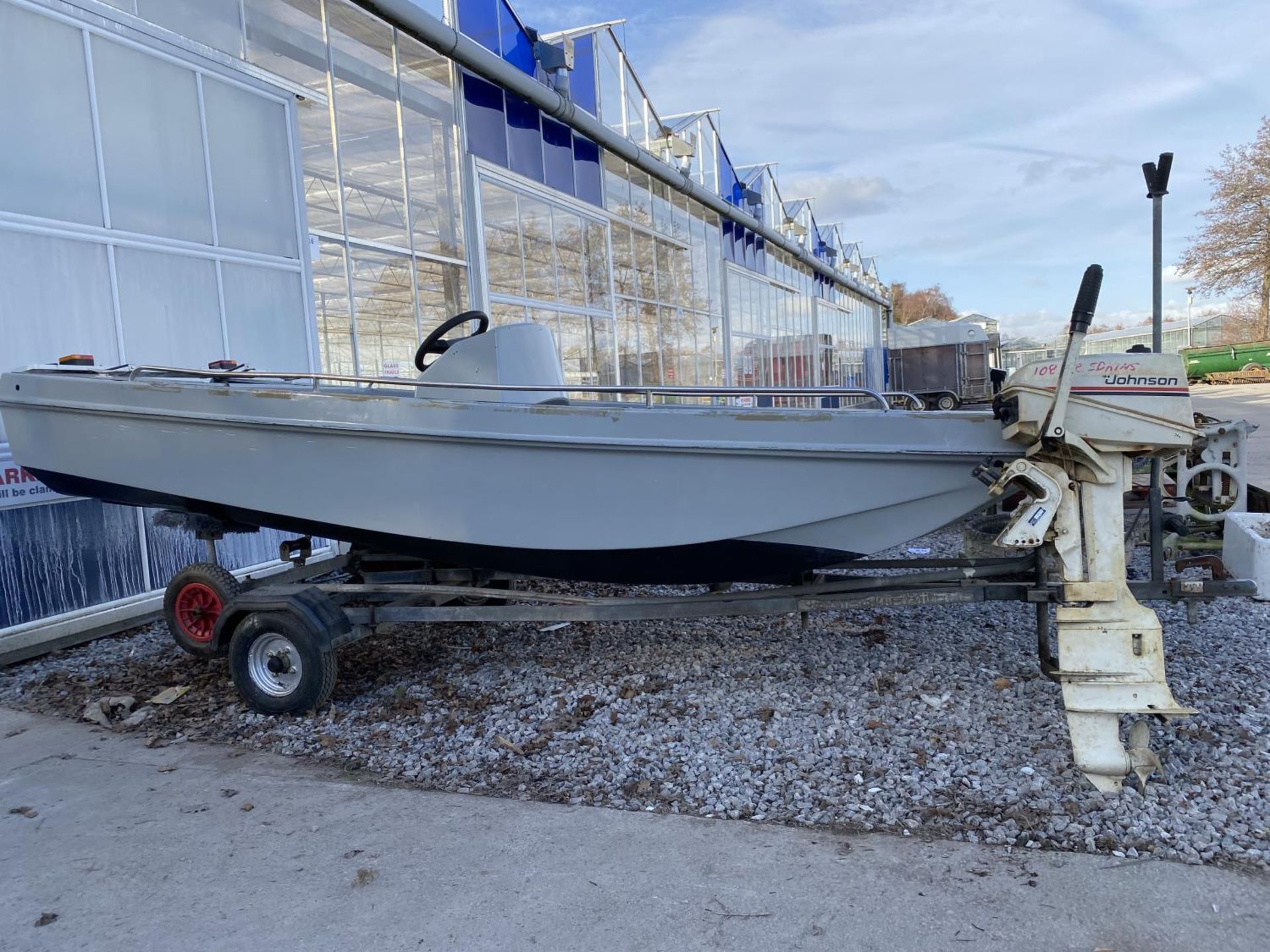 A FISHING BOAT WITH JOHNSON SEAHORSE OUTBOARD MOTOR MODEL NO: J5RTCTA COMPLETE WITH A FOLDING