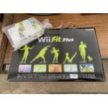 A NINTENDO WII FIT BOARD AND THREE WII GAMES