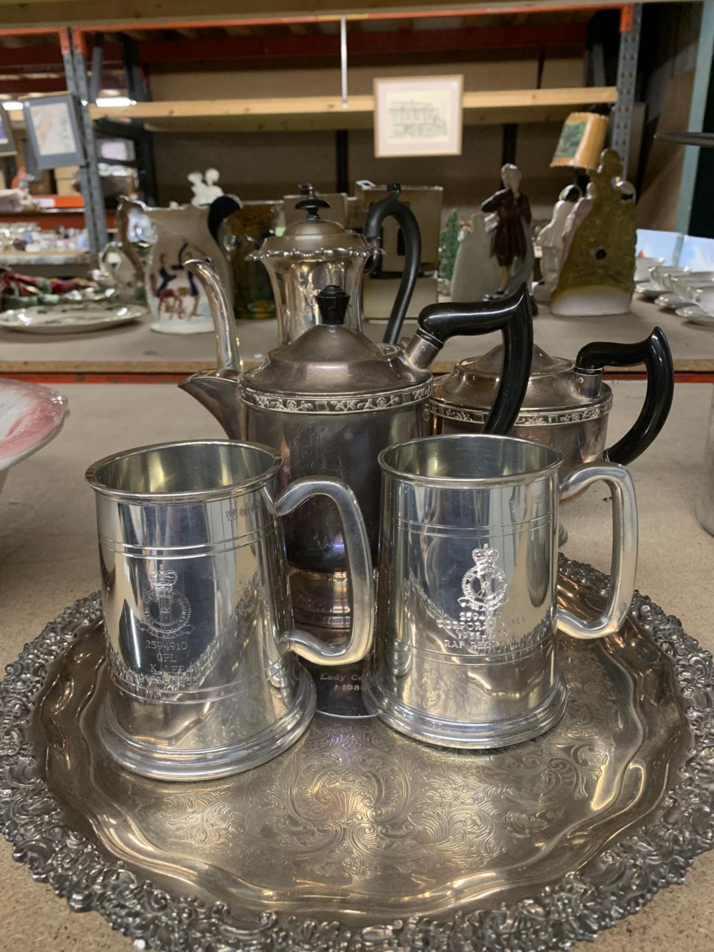 A SILVER PLATED TRAY WITH TWO TANKARDS, A TEAPOT AND TWO COFFEE POTS