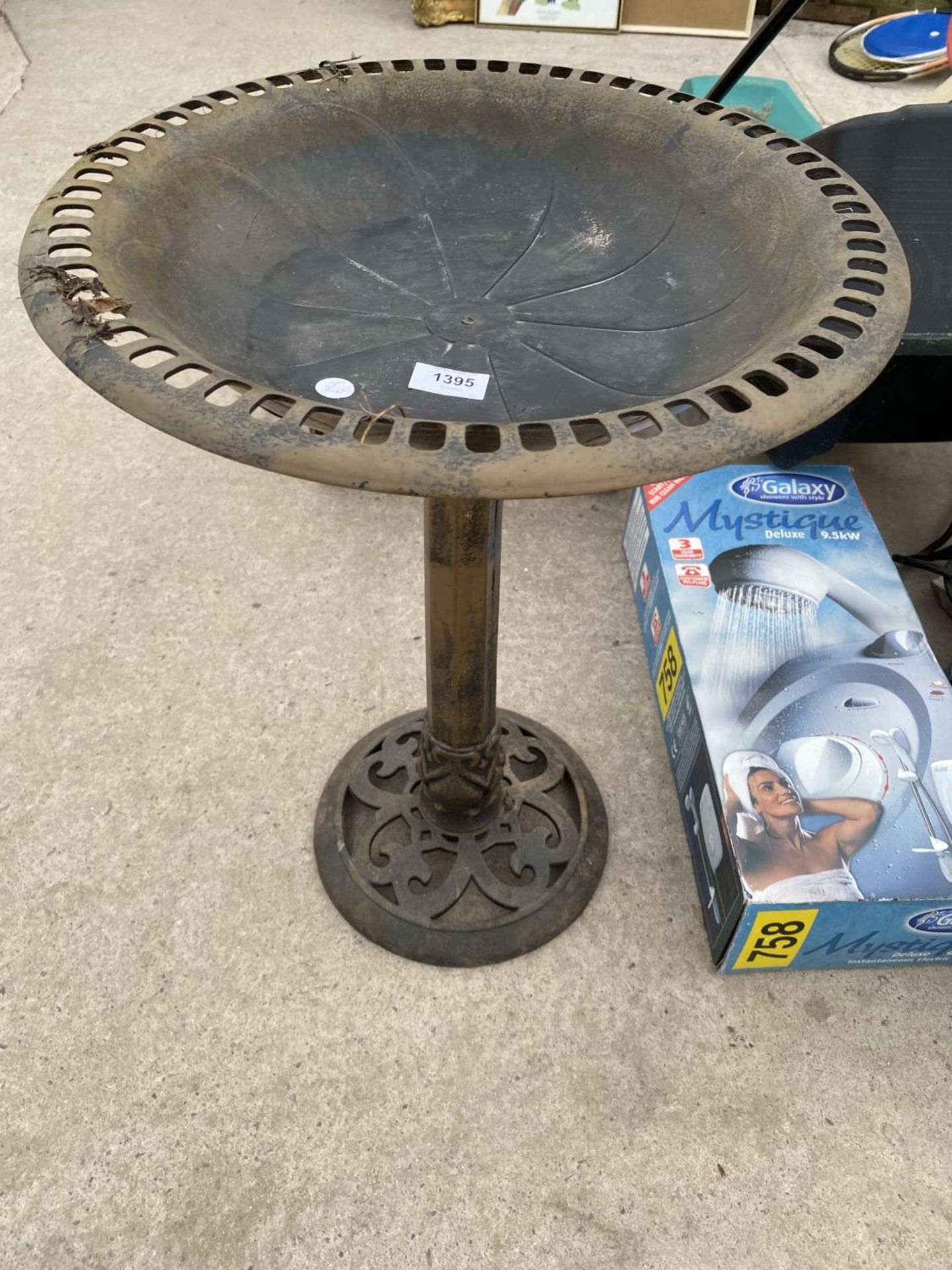 A PLASTIC BIRD BATH