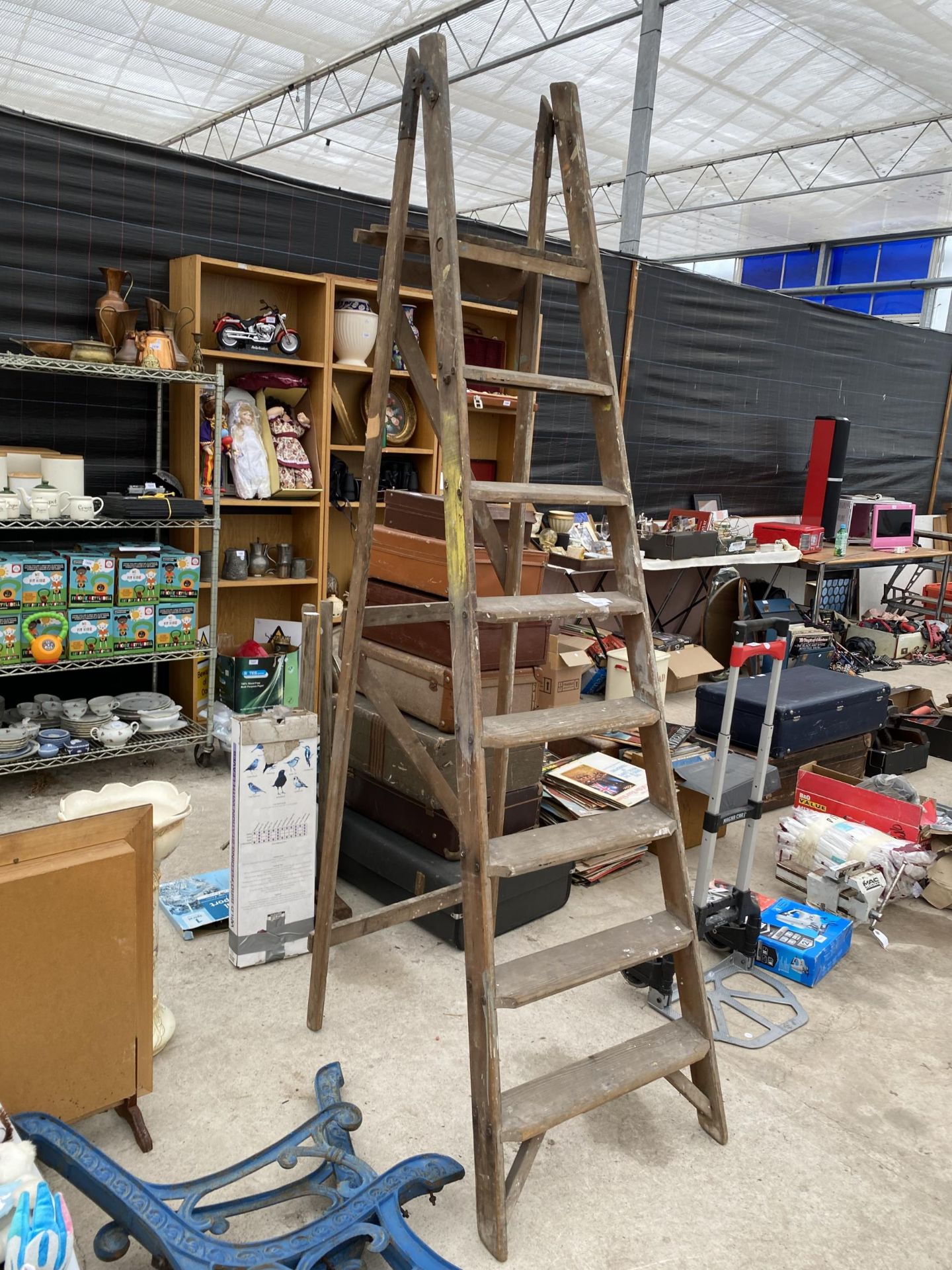 A VINTAGE SEVEN RUNG WOODEN STEP LADDER