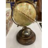 A WORLD GLOBE WITH A COMPASS ON A WOODEN BASE HEIGHT APPROX 24CM