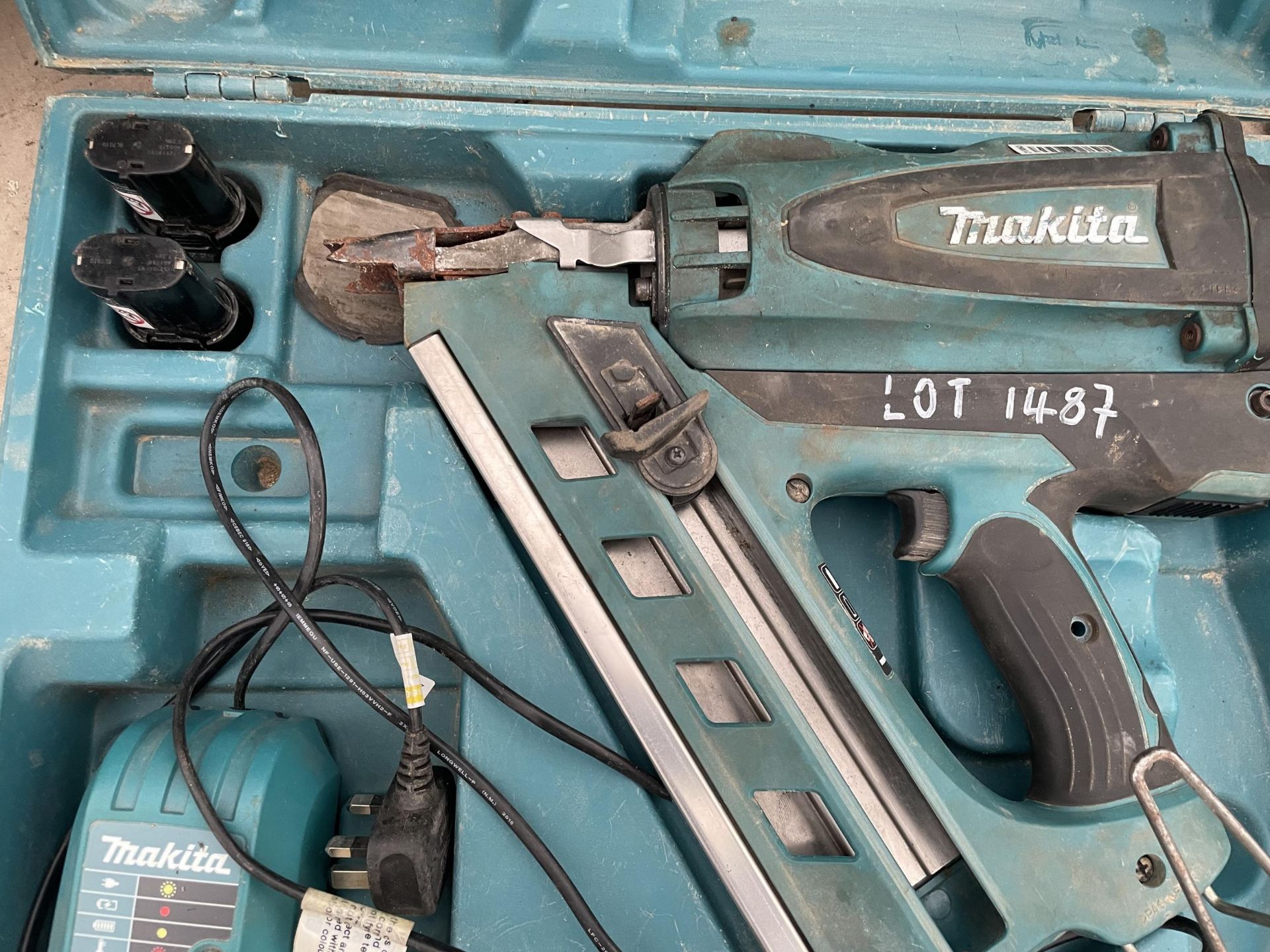 A MAKITA BATTERY POWERED NAIL GUN WITH CHARGER AND TWO BATTERIES - Image 2 of 2