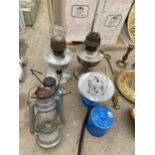 AN ASSORTMENT OF CAMPING STOVES, OIL LAMPS AND A PARAFIN LAMP ETC
