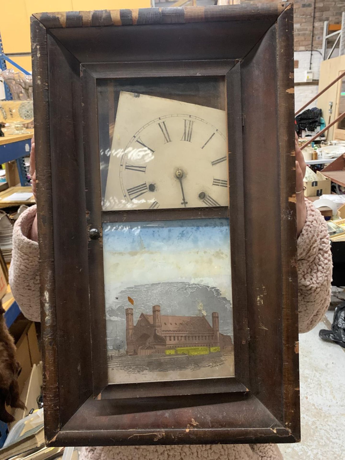 A VINTAGE JEROME & CO WALL CLOCK IN NEED OF RESTORATION