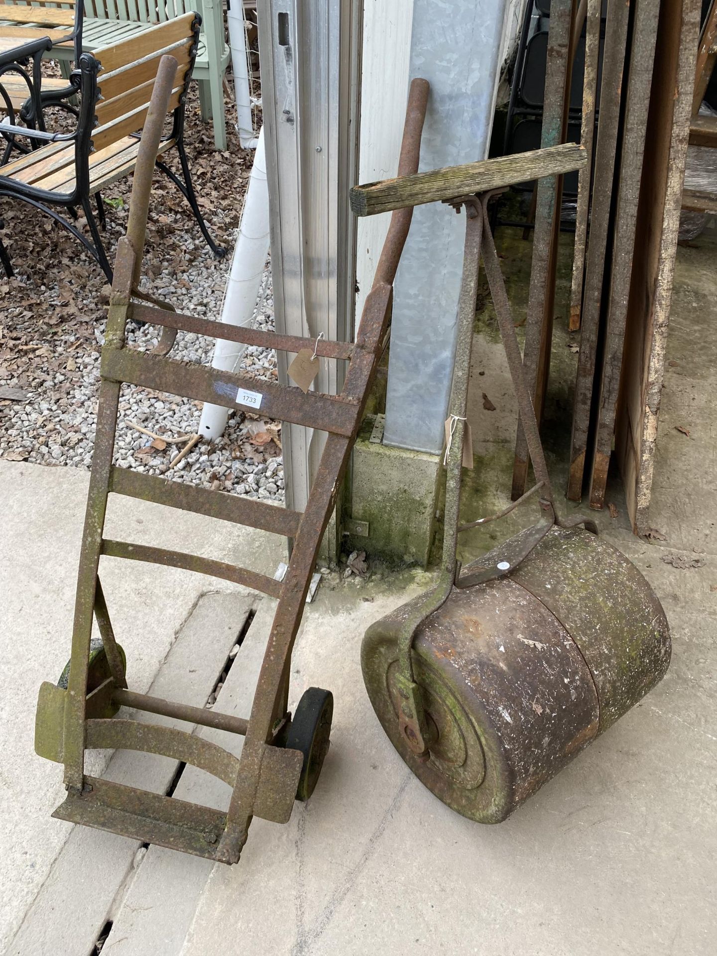 A VINTAGE METAL SACK TRUCK AND A GARDEN ROLLER