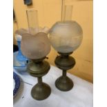 TWO VINTAGE OIL LAMPS WITH BRASS BASES, ONE WITH A PALE PINK FLUTED EMBOSSED GLASS SHADE, THE