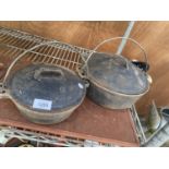 TWO CAST IRON LIDDED COOKING POTS