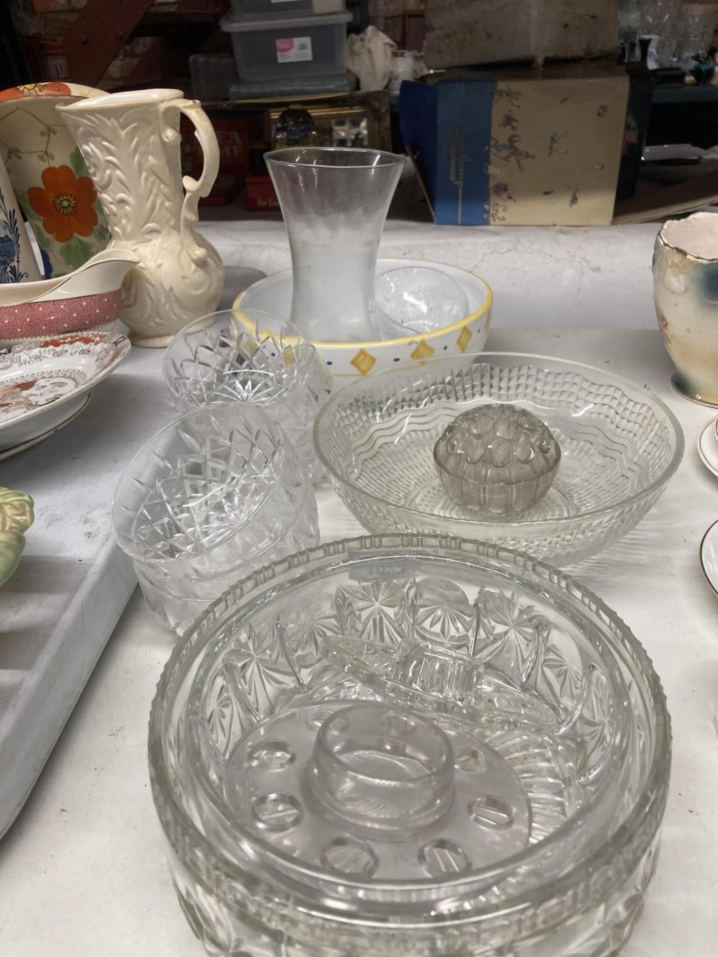 A LARGE COLLECTION OF GLASSWARE TO INCLIUDE BOWLS, FLOWER ARRANGING FROGS, VASES ETC