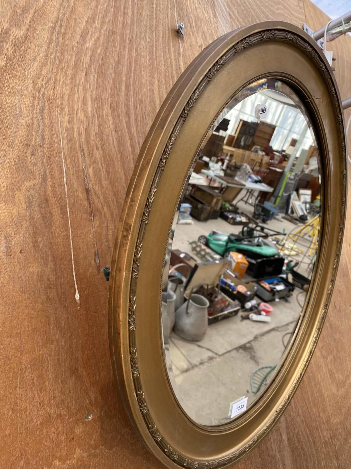 AN OVAL GILT FRAMED BEVELED EDGE WALL MIRROR - Image 2 of 3