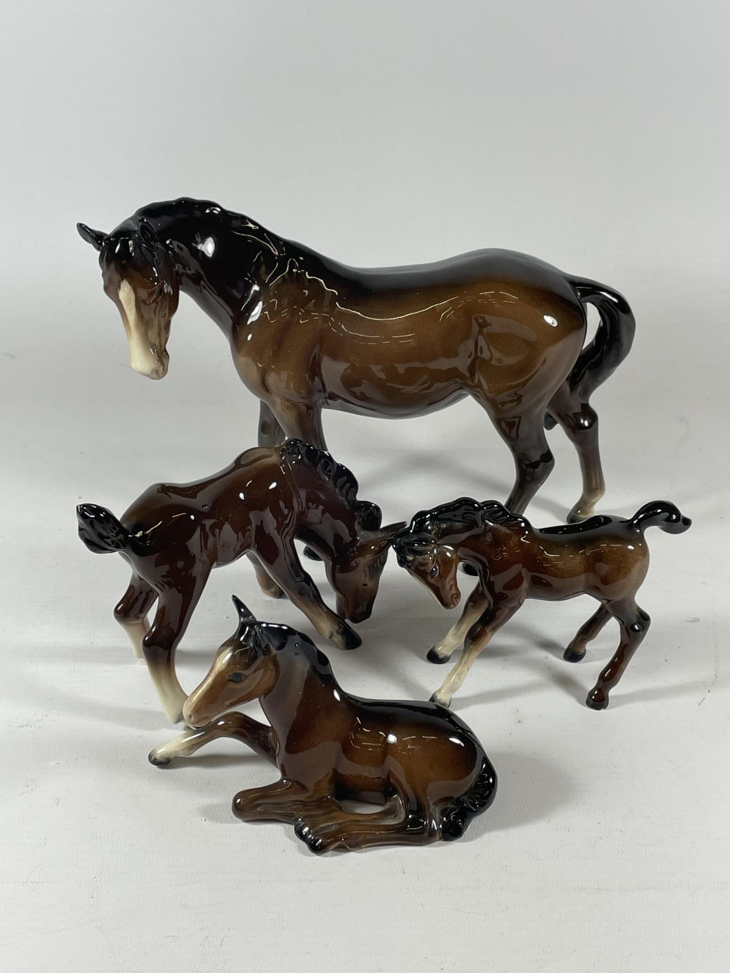 A MIXED LOT OF THREE BESWICK HORSES AND A FURTHER GERMAN EXAMPLE