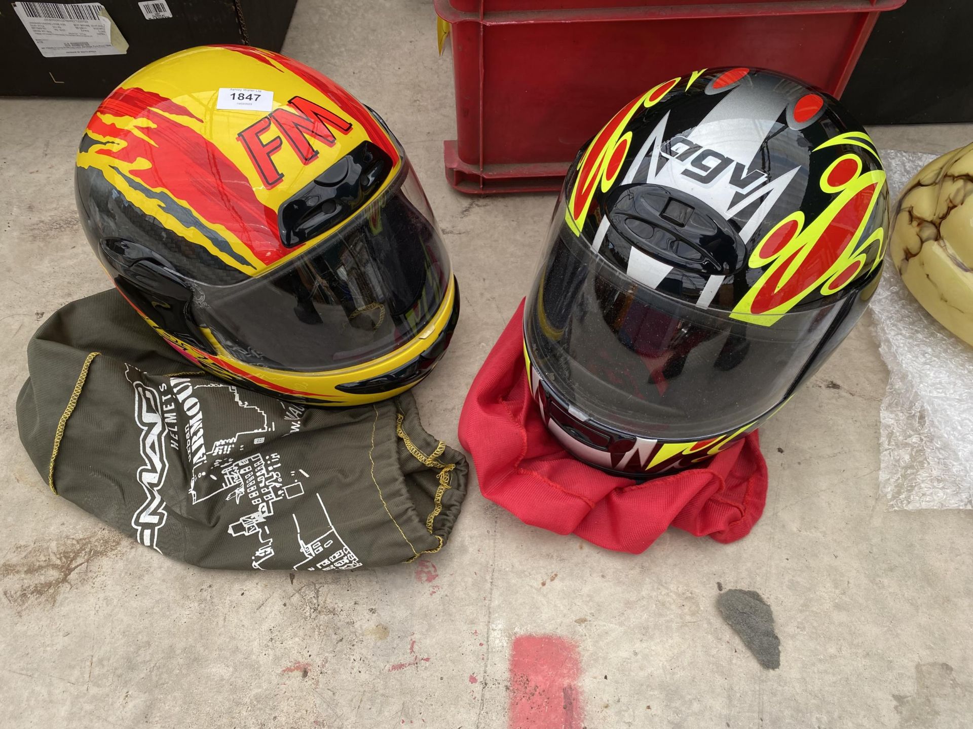 AN AGV MOTORBIKE HELMET AND A FURTHER FM MOTORBIKE HELMET